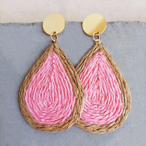 Pink raffia teardrop statement earrings with woven natural raffia trim and gold disc tops.