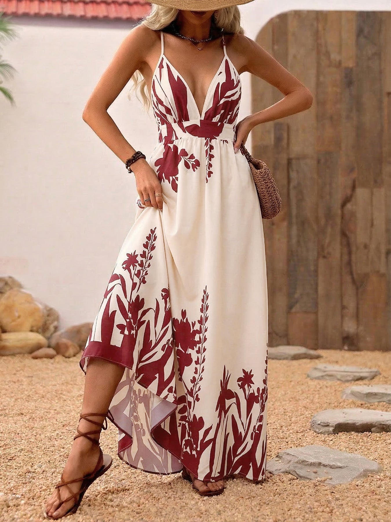 Maxi dress with deep V-neck, floral pattern, spaghetti straps, and a-line cut.