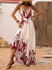 Maxi dress with deep V-neck, floral pattern, spaghetti straps, and a-line cut.