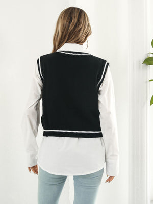 Black acrylic knit vest with white trim and argyle pattern, V-neck, sleeveless.