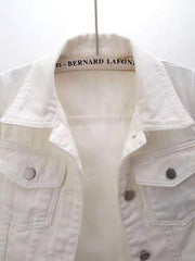 White denim trucker jacket with button-flap chest pockets and collar detail.