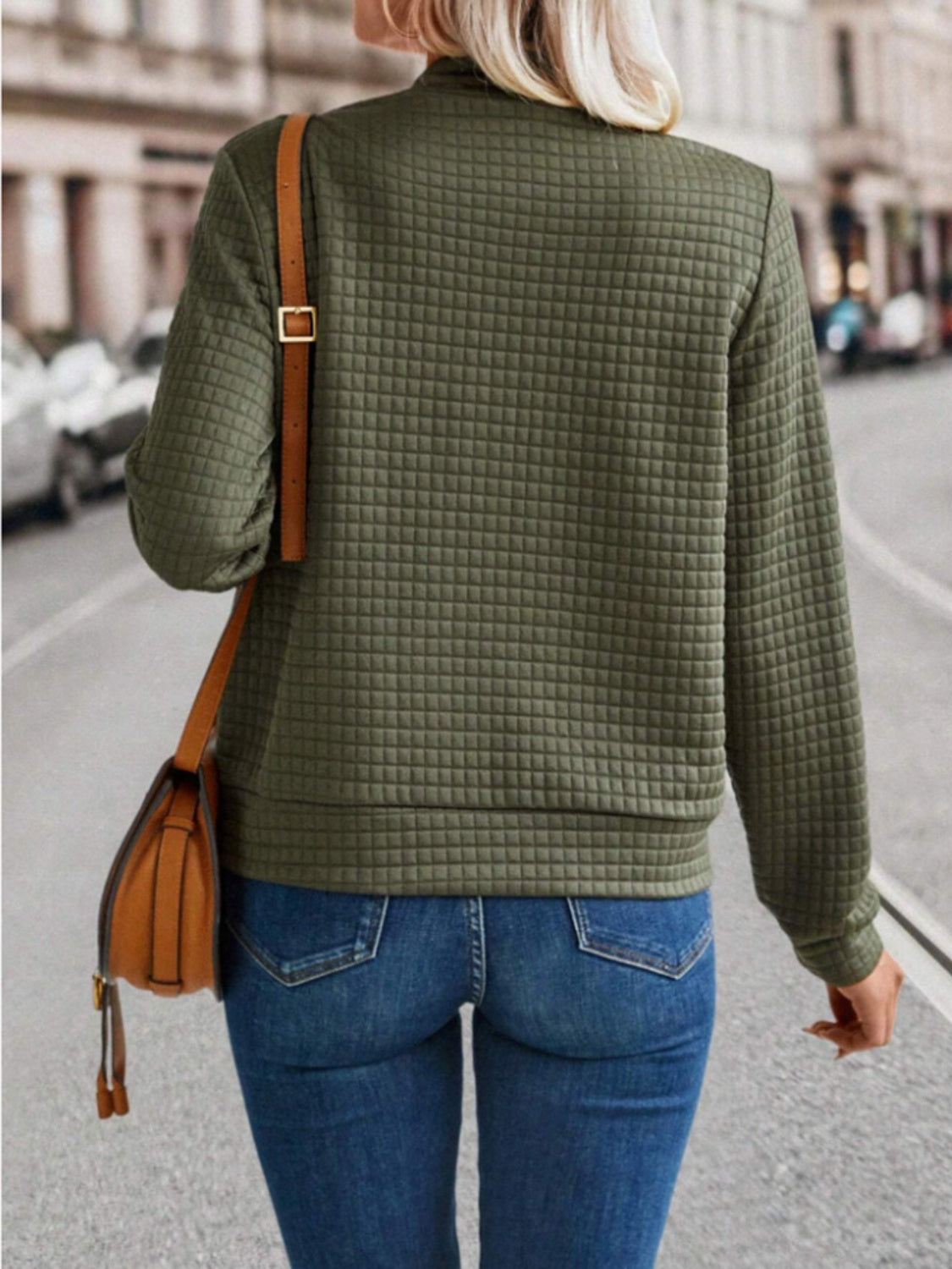 Army green quilted bomber jacket with zip closure, long sleeves, and crew neck.
