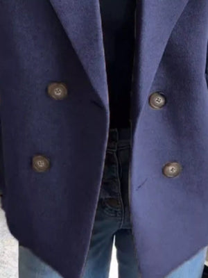 Navy double-breasted wool blend blazer with button detail and lapel collar.