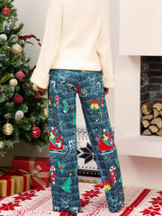 Festive print wide-leg lounge trousers in blue with Santa, reindeer, and candy cane Christmas motifs.