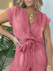 Belted tie-waist romper in burnt coral with V-neck and button front.