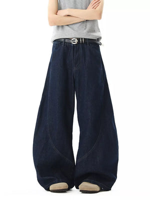 Men's dark wash cotton wide-leg jeans with pockets and curved seam detail.