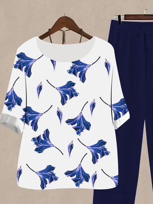 White floral print half sleeve top with dark blue pants