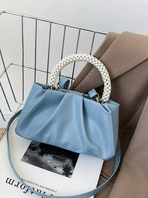 Blue crossbody bag with pearl-beaded handle and ruched detail