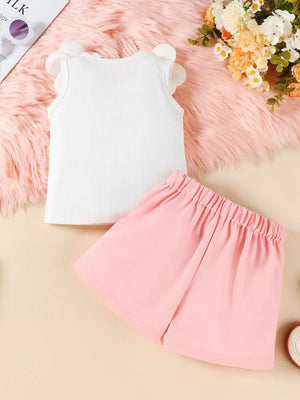 Baby girl white ribbed tank top with floral applique sleeves and pink bow skort.