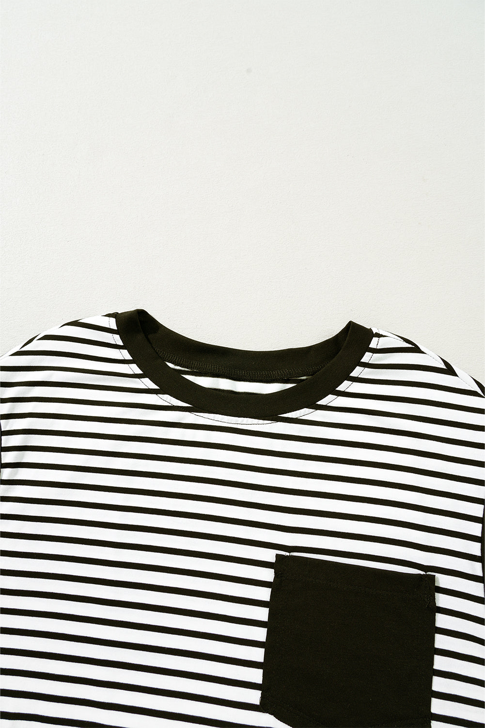 Black and white striped t-shirt with a black chest pocket and crew neck.