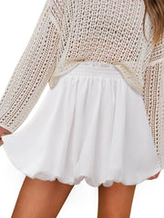 White bubble hem mini skirt with elastic waist, styled with a crochet sweater.