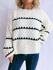 White acrylic knit jumper with black chevron stripes and textured diamond pattern.