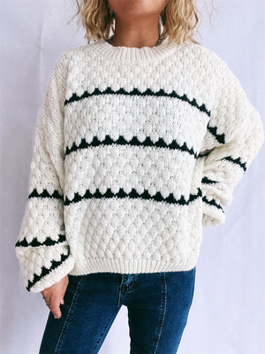 White acrylic knit jumper with black chevron stripes and textured diamond pattern.