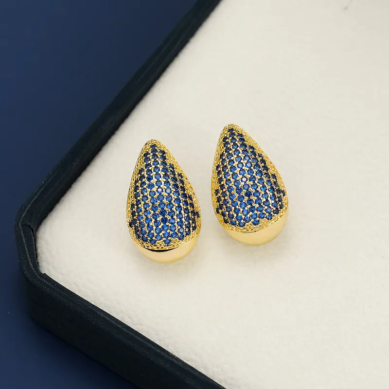 Pave teardrop studs with gold base and royal blue stones.