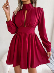 Red fit-and-flare mini dress with keyhole neckline, long sleeves, and buttoned cuffs.