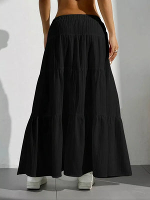 Black tiered maxi skirt with elastic waistband and textured fabric.