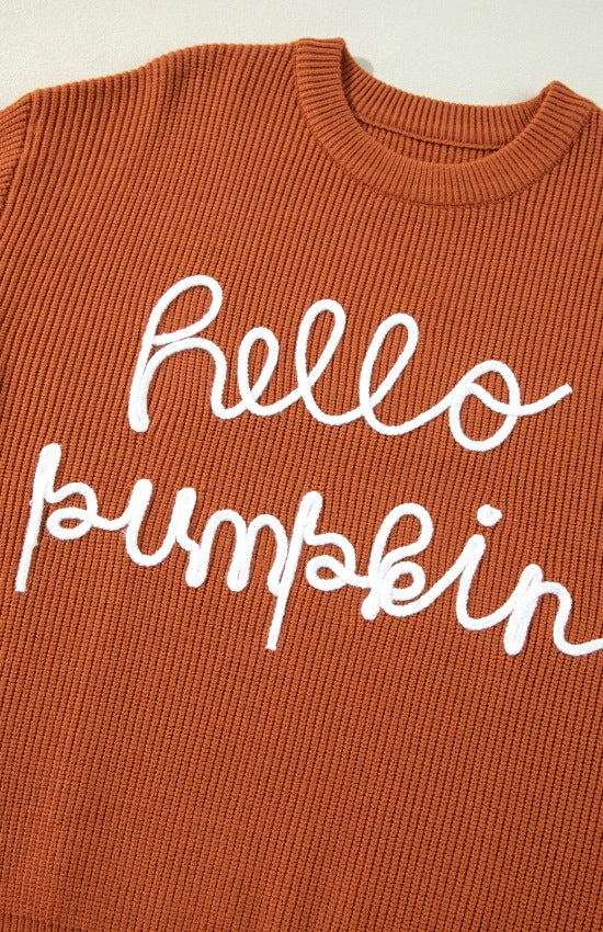 Terracotta knit sweater with white "hello pumpkin" script detail.