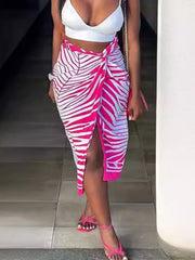 Twisted knot midi skirt with slit in rose red zebra print, featuring a tie detail and high slit.