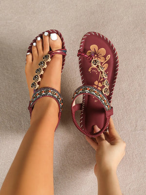 Deep Red embellished thong sandals with floral detail and beaded ankle strap.