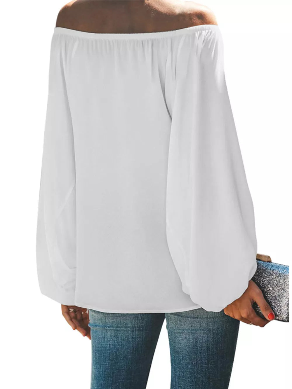 White off-shoulder maternity blouse with balloon sleeves, styled with jeans.
