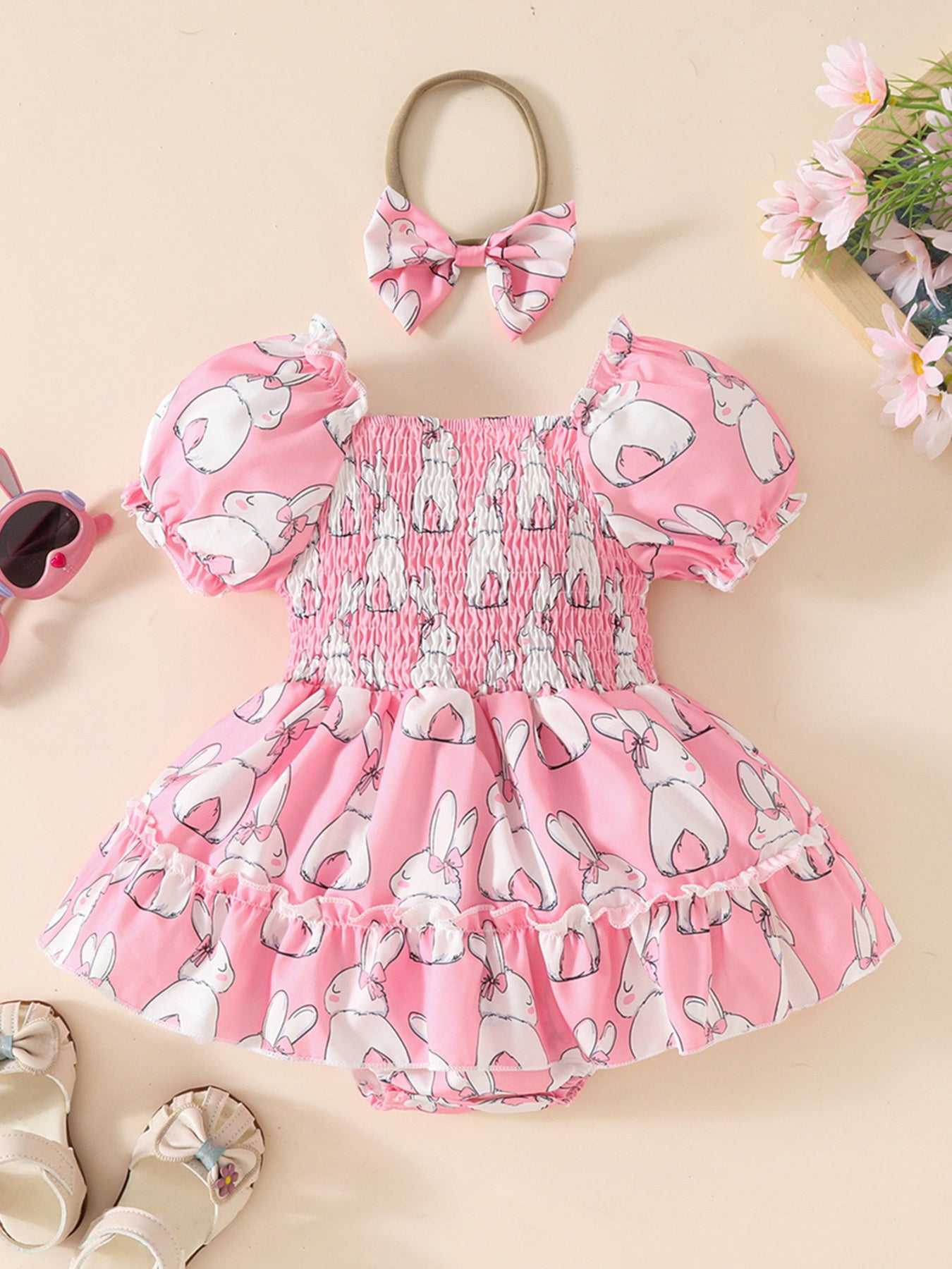 Pink bunny print baby dress with smocked bodice and puff sleeves, with matching headband.