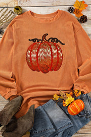 Orange corduroy sweatshirt with sequin pumpkin detail.