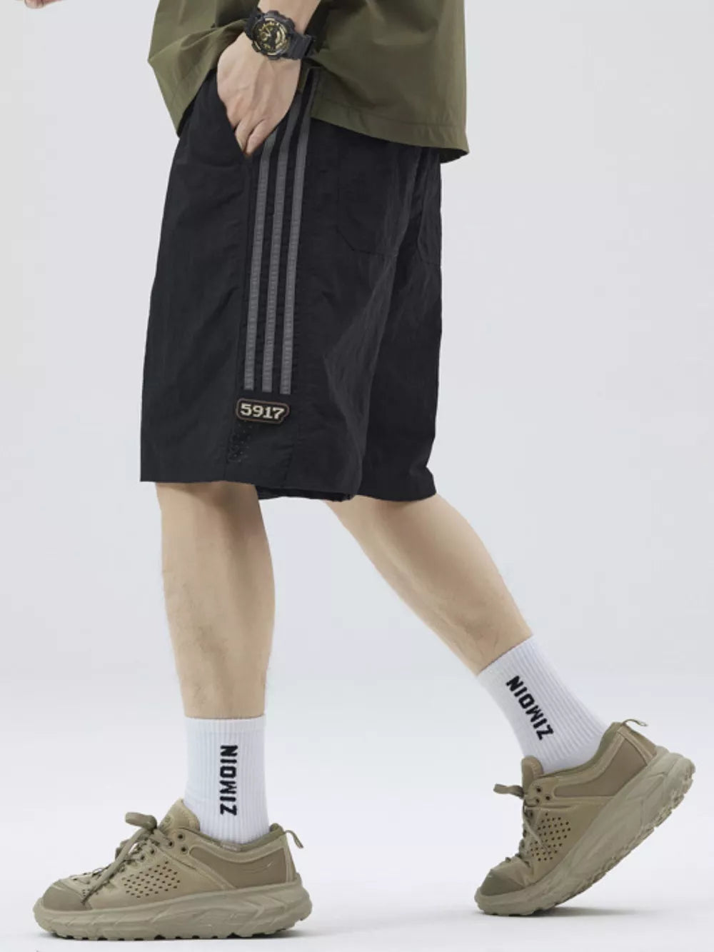 Black casual drawstring shorts with grey sporty stripes and a small patch detail.