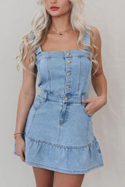 Button-front denim sundress with square neckline, ruffle hem, and adjustable straps.