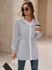 Gray hooded jacket with cinched waistline and white zipper detail.