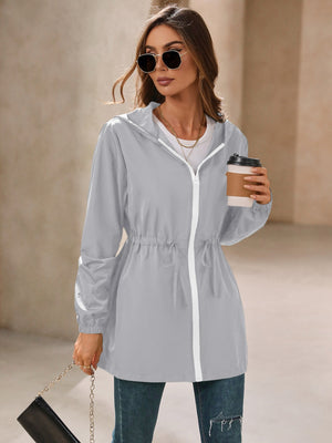 Gray hooded jacket with cinched waistline and white zipper detail.