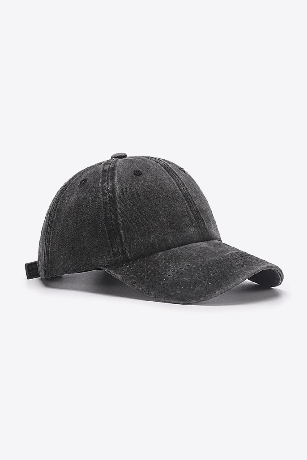 Washed cotton baseball cap in black with adjustable strap detail.