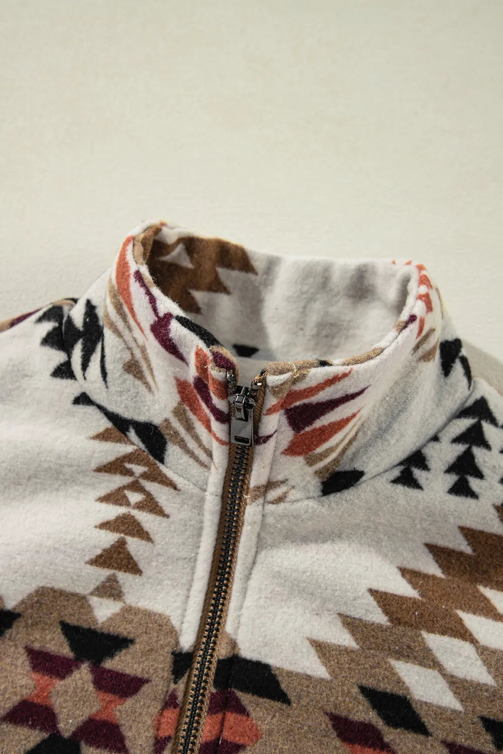 Southwestern quilted zip-up jacket in eggshell with a geometric pattern and stand-up collar.