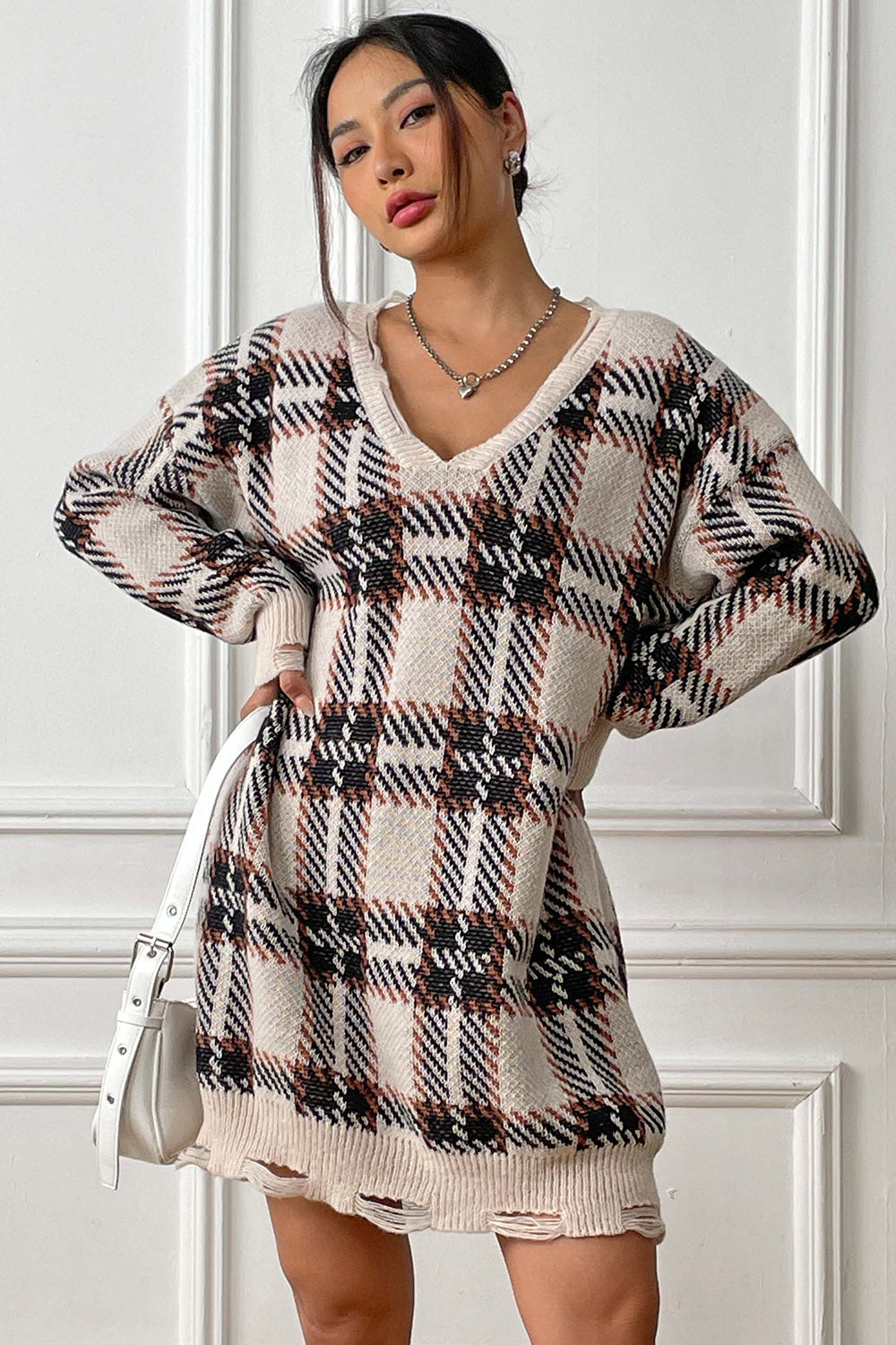 Plaid knit mini dress with distressed hem and V-neck.