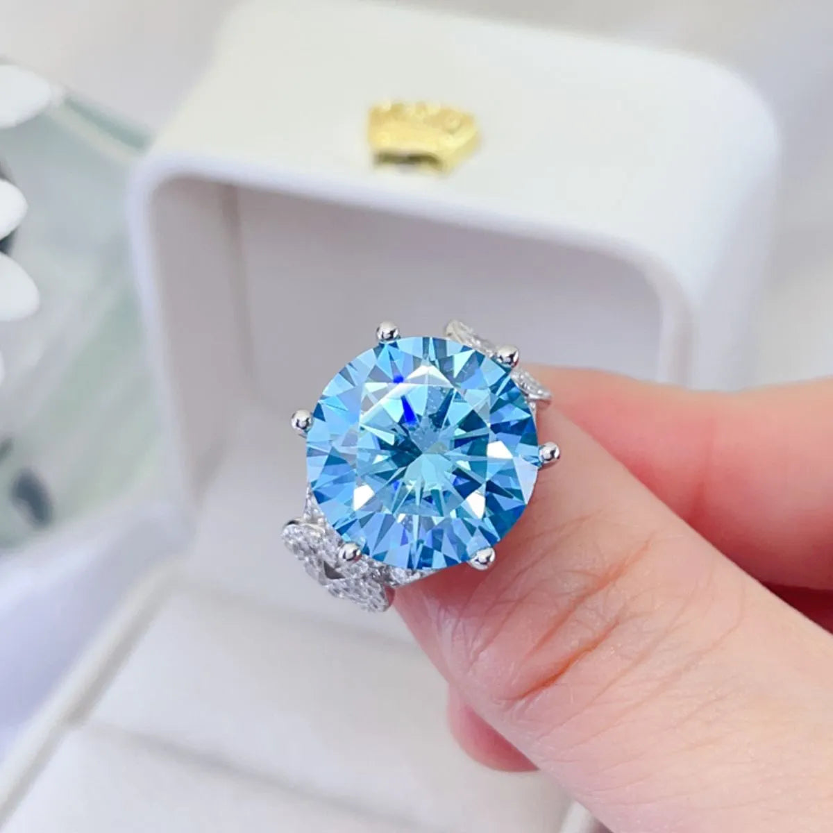 Celestial blue moissanite knot ring with sparkling accents.