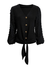 Black waffle knit tie front blouse with Swiss dot sleeves and button front.