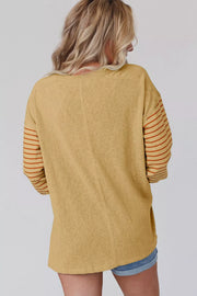 Mustard maternity shirt with bishop sleeves featuring horizontal stripes and a crew neck.