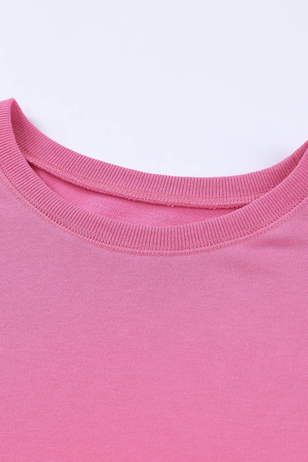 Rose pink crewneck sweatshirt with ribbed neckline and cuffs.