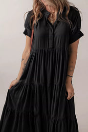 Black tiered maxi dress with short sleeves, collared neckline, and hidden placket.