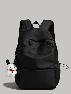 Black nylon drawstring backpack with padded straps and plush charm