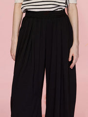 Black pleated drape palazzo trousers with a comfortable elastic waistband.