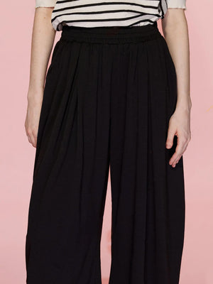 Black pleated drape palazzo trousers with a comfortable elastic waistband.