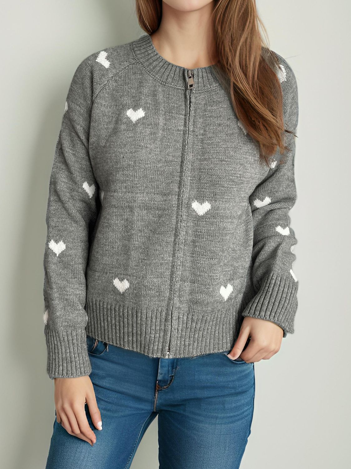 Gray zip-through knit cardigan with white heart print, crew neck, long sleeves, ribbed cuffs and hem.