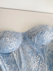 Luxe floral lace tube top in blue with white lace overlay and corset detail.