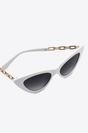 White cat-eye sunglasses with gold chain detail and dark lenses