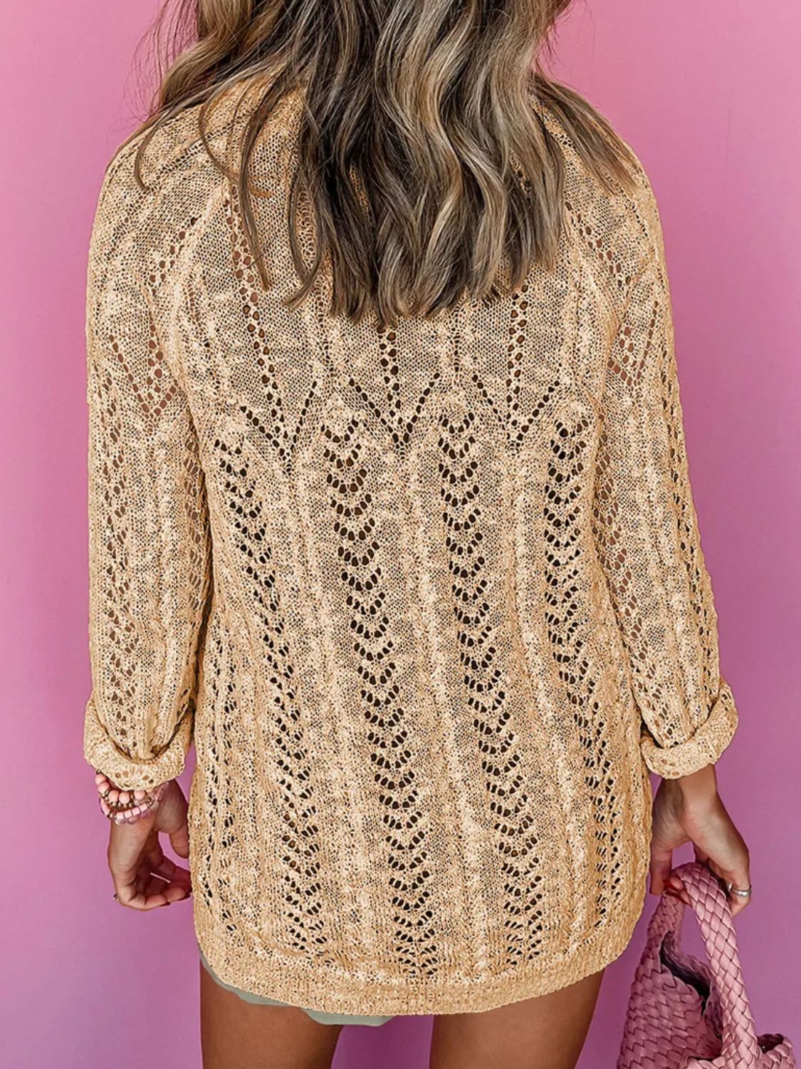 Tan openwork chevron knit cardigan with long sleeves and a relaxed fit.