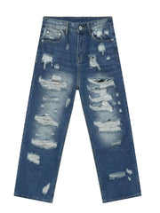Oversized ripped denim jeans in medium wash with raw edge detail and distressed accents.