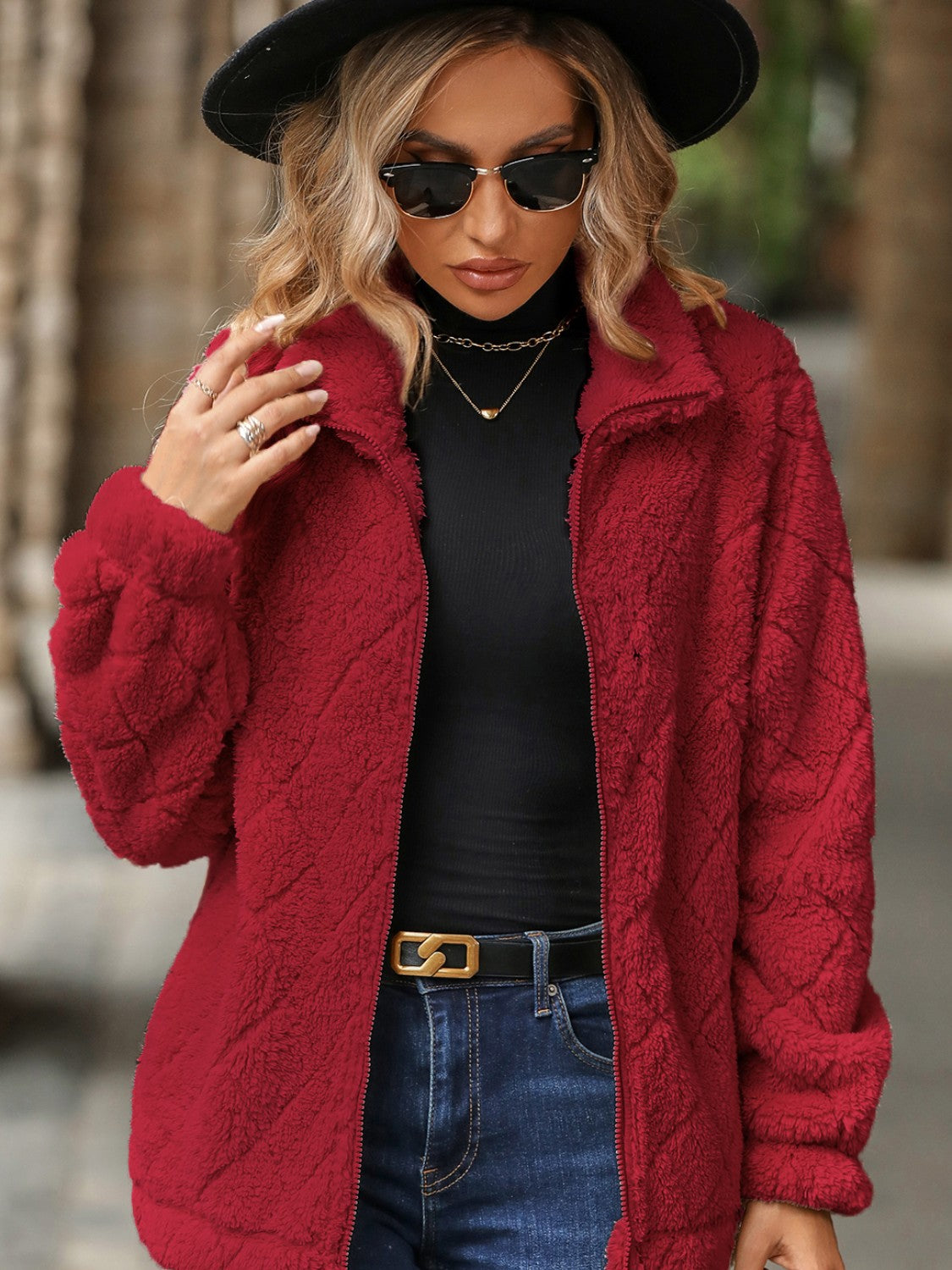 Textured teddy zip-up jacket in deep red with a diamond pattern, long sleeves, and a stand-up collar.