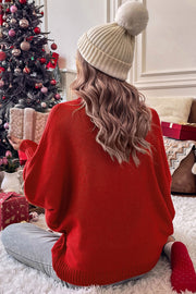 Red acrylic dolman sleeve turtleneck sweater with relaxed fit, styled with a beanie and gift.