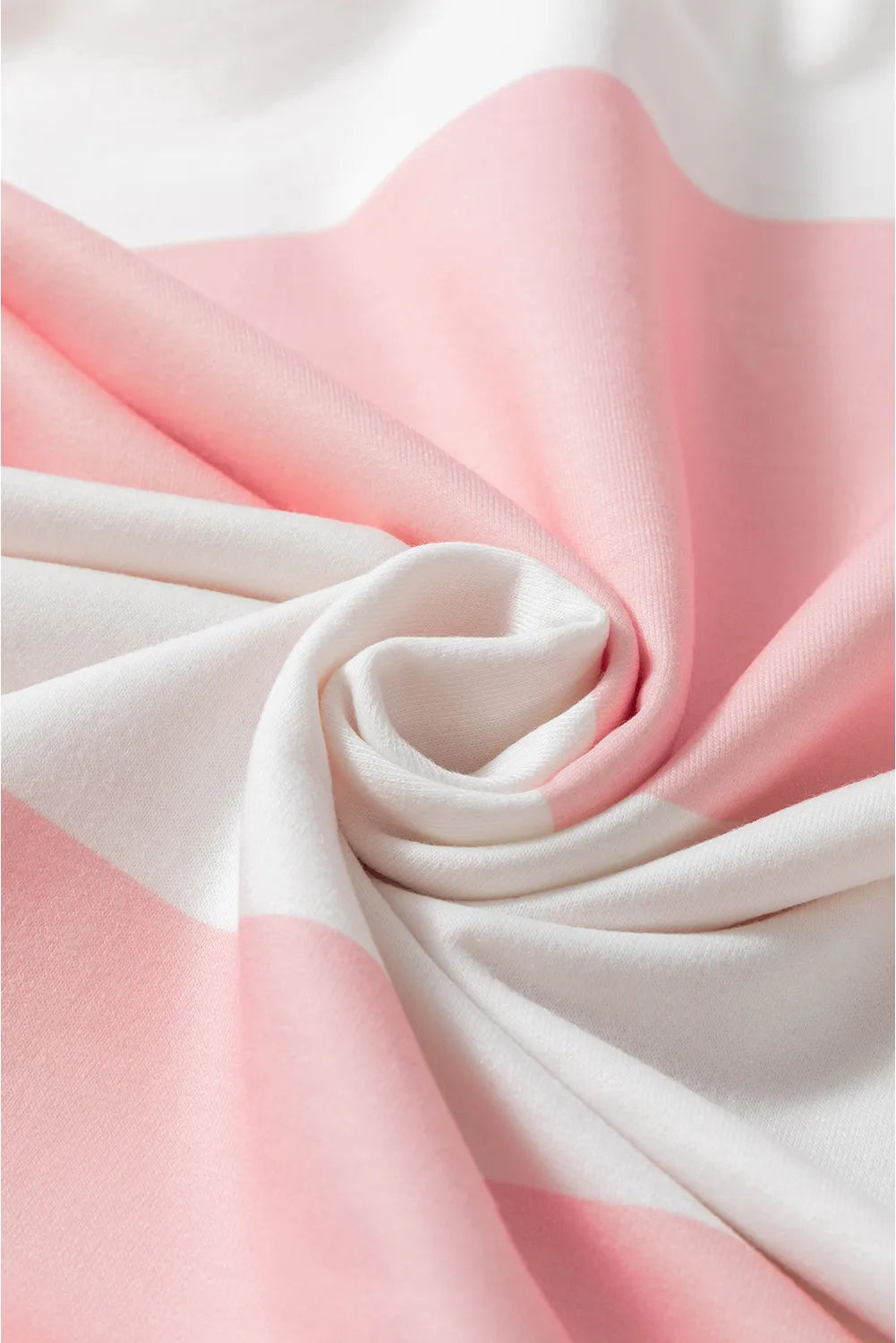 Striped sweatshirt in blush pink and white with a soft knit texture.
