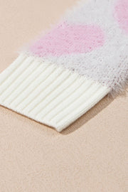 Fuzzy heart jacquard knit sweater in blush pink with ribbed cuffs and hem.